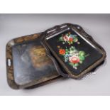 A toleware two-handled tray with central rural scene decoration, 24 1/4" wide, and three other
