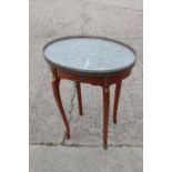 A Louis XVI design mahogany and satinwood banded oval marble top gallery table, on cabriole