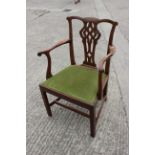 A Georgian provincial mahogany elbow chair with pierced splay and drop-in seat, on chamfered