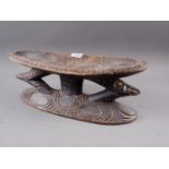 A central African carved and painted wooden head rest, 17 1/2" wide