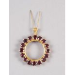A 9ct gold and garnet circular pendant, 1 1/4" dia, 8g
