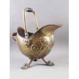 A late 19th century brass coal scuttle with embossed decoration, on three paw supports, 13 1/2" high