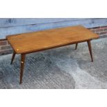 A 1950s teak coffee table, on turned supports, 48" wide