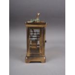 A brass cased carriage clock with white enamel dial and Roman numerals, with key supplied, by