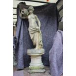 A cast stone figure of a water carrier, 42" high, on capital stand