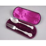 A silver part christening set, comprising spoon and fork (lacking knife), in fitted box, 3.6oz