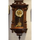 A late 19th century walnut cased wall clock with striking movement and pierced case, 26" high