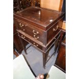 A mahogany canteen with brass side carrying handles, fitted three drawers and side slides, on