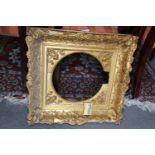 A 19th century giltwood deep swept picture frame with circular mount, 20 1/4" wide x 19 1/4" high