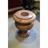 A turned pink granite urn, 12" high