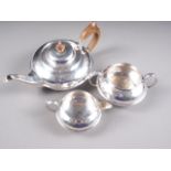 A silver three-piece teaset with planished decoration, the teapot with fruitwood handle and knop,