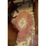 A Super Ganges Indian washed wool rug with floral decoration on a pink ground, 72" x 48" approx