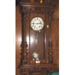 An American cased wall clock with glazed panels and eight-day striking movement, 42" high