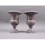 A pair of early 20th century cast iron campana urns, 8" high
