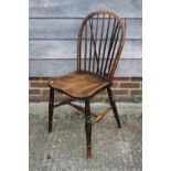 A Windsor beech, elm and ash spindle back chair with panel seat, on turned and stretchered supports