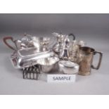 A quantity of silver plate, including a pair of entree dishes and covers, a teapot, a hip flask
