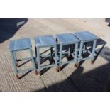 Four blue painted panel seat high stools, on stretchered supports, 13" square x 24" high