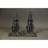 A pair of 19th century cast iron burnished door stops, formed as 19th century gentlemen, on