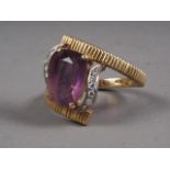 An 18ct gold ring, set amethyst and white sapphire
