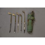 A 9ct gold manicure set, formed as golf clubs in a leather golf bag