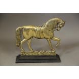 A 19th century cast brass door stop, formed as a horse, on a cast iron stepped base, 9 1/2" high