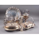 A silver plated fluted biscuit box with engraved decoration, a pair of candlesticks, a teapot, trays