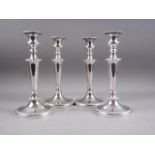 A set of four silver plated candlesticks with phoenix motif, 10 1/2" high