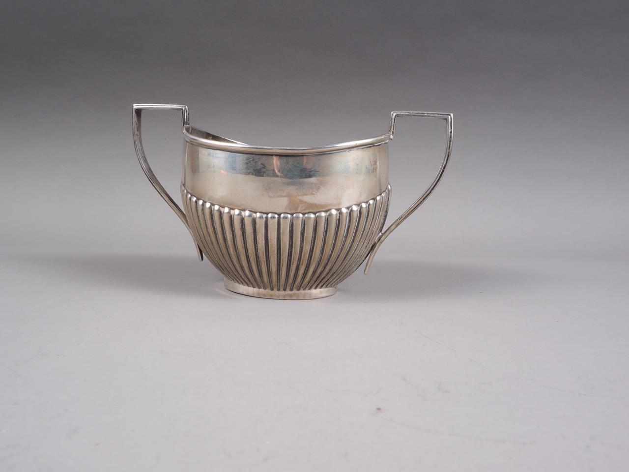 A silver half-fluted two-handled sugar bowl, 6 1/2" wide, 5.6oz troy approx