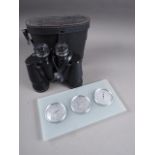 A pair of 10x50 binoculars, in case, and a wall mounted aneroid barometer, thermometer and