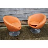 A pair of 1960s tub-shape chairs, upholstered in an orange leatherette, on conical aluminium bases