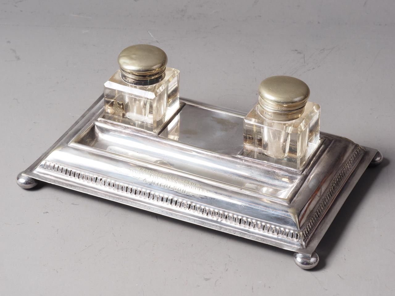 Three pairs of silver plated knife rests and a plated inkstand with inkwells