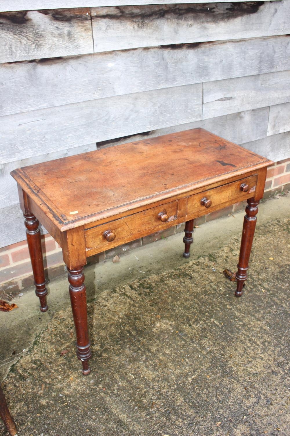 A mahogany side table, fitted two drawers, on turned supports, 34" wide x 17" deep x 26" high