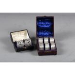 A set of six silver napkin rings, 2oz troy approx, in case, and a pair of white metal pierced and