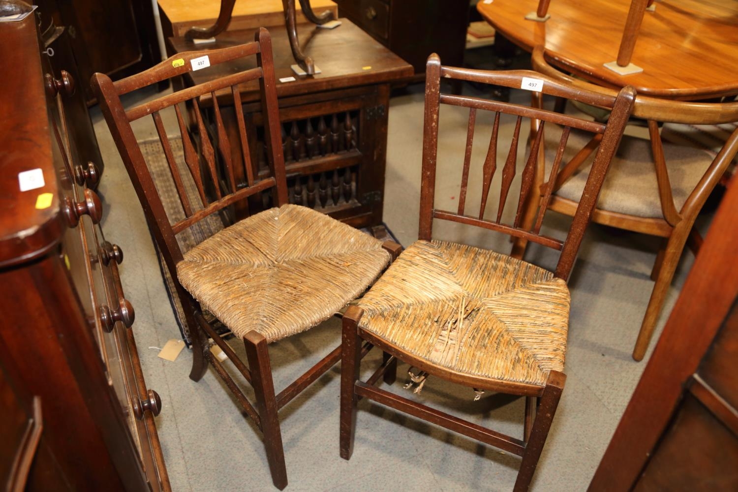 A pair of mahogany spindle back rush seat side chairs, on square taper supports