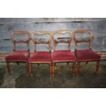 A set of five Victorian carved walnut loopback standard dining chairs, upholstered in a striped