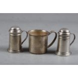 A pair of sterling silver kitchen peppers with handles and a similar sterling christening mug with