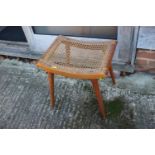 A 1950s cane seat dressing stool, on turned splay supports, 17" wide x 13 1/2" deep x 18" high
