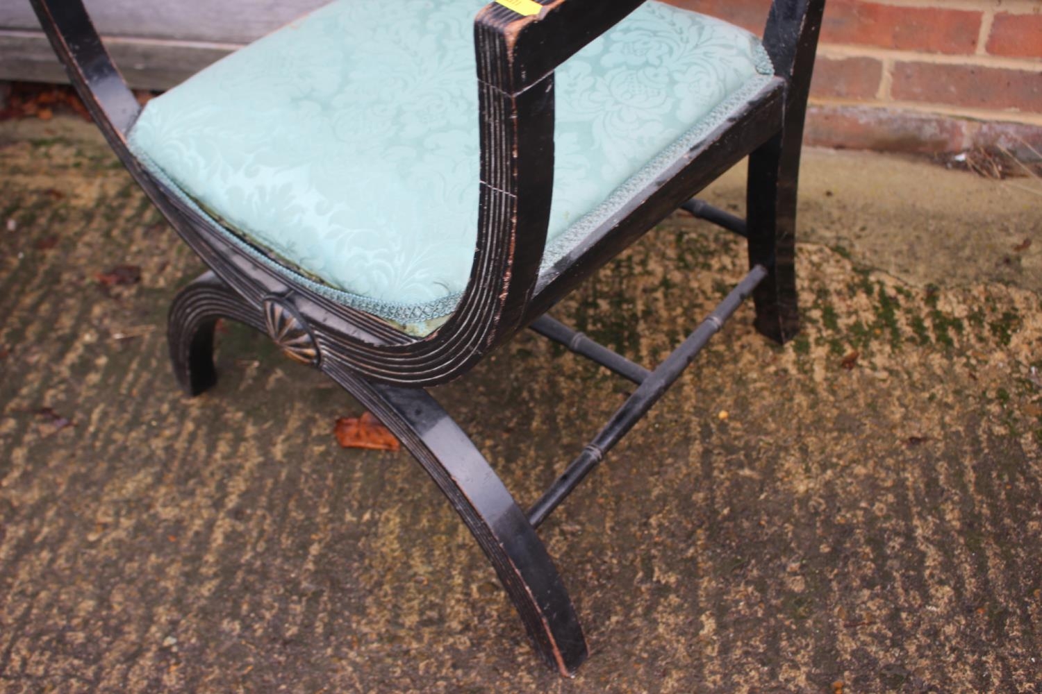 A late 19th century ebonised reeded 'X' frame elbow chair with padded seat and back - Image 2 of 2