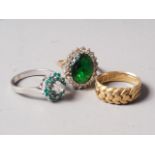 An 18ct gold ring, plaited design, 7.6g, a 9ct gold ring, set large central green stone with