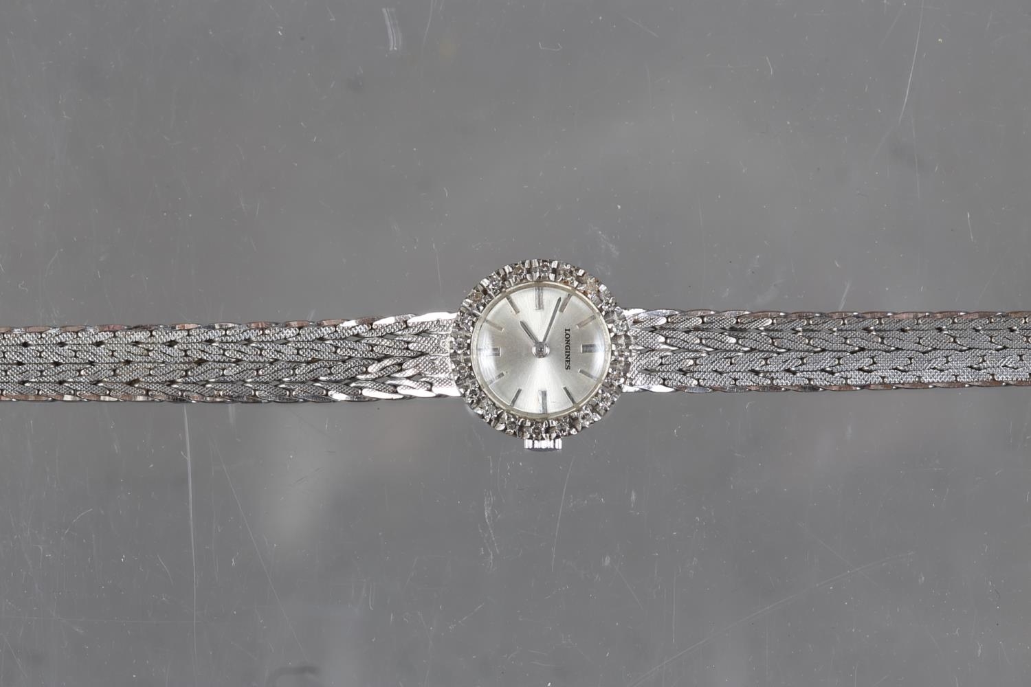 A lady's 18ct white gold Longines bracelet watch with diamond bezel, silvered dial and baton