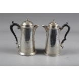 A silver hot water pot with tapered body and stepped base and ebonised handle, 7 1/2" high, and