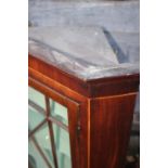 A 19th century mahogany corner hanging cabinet enclosed astragal glazed door, 30" wide x 17" deep