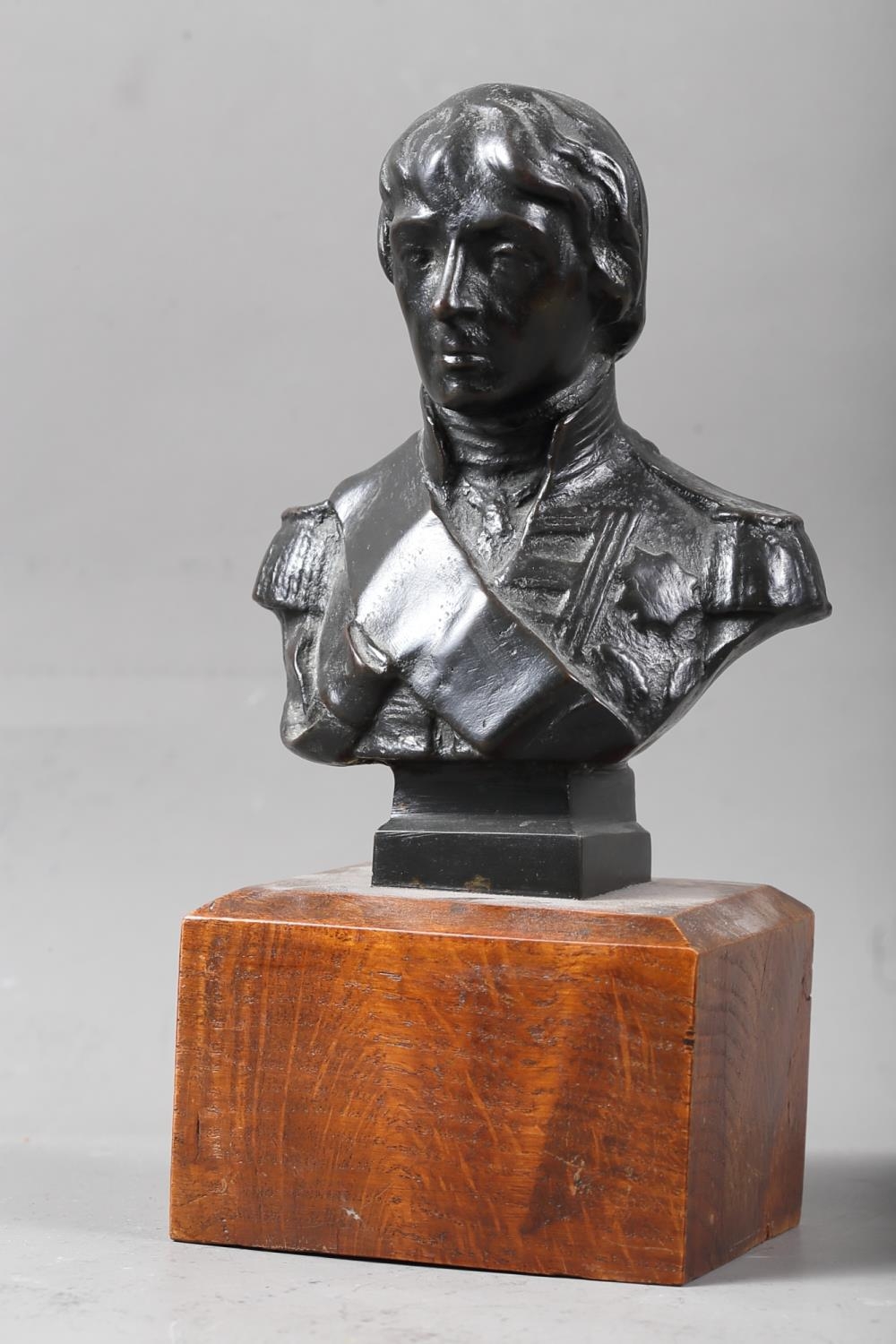 A 19th century patinated bronze portrait bust of Nelson, 3 3/4" high, on oak base