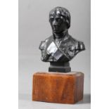 A 19th century patinated bronze portrait bust of Nelson, 3 3/4" high, on oak base