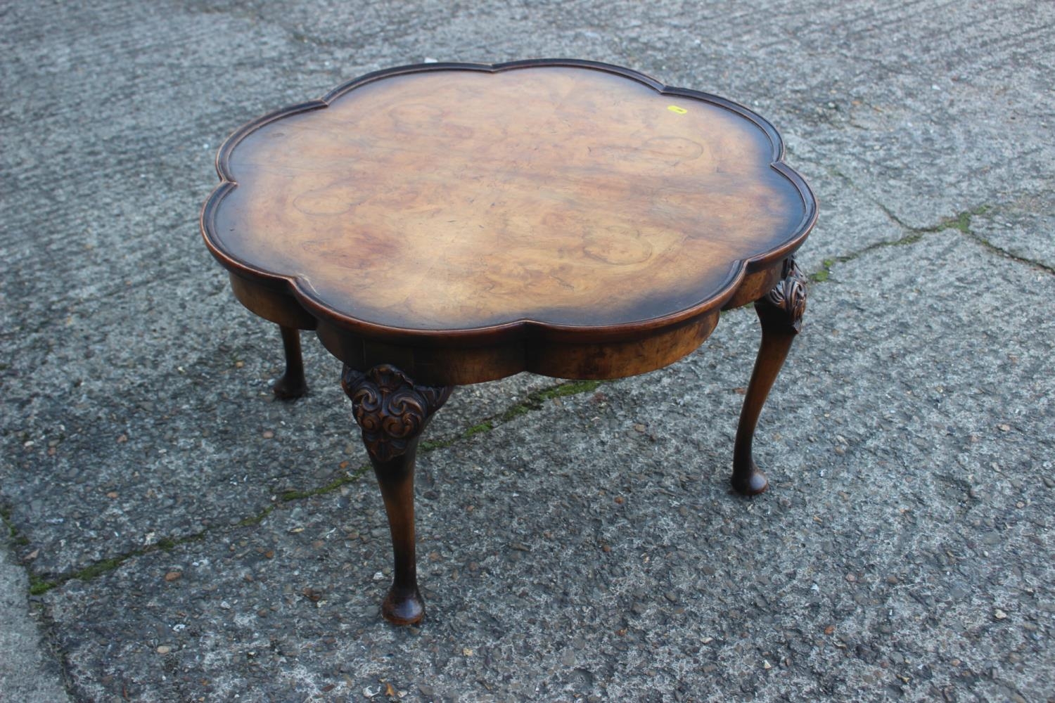 A walnut ocatafoil shape top low coffee table, on carved cabriole supports, 25" dia x 15" high