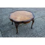 A walnut ocatafoil shape top low coffee table, on carved cabriole supports, 25" dia x 15" high