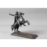 A bronze figure of Napoleon mounted on a rearing horse, on square base, 10 1/2" high