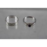 An 18ct white gold wedding band, 4.1g, and a white gold engagement ring set sapphire and diamonds,