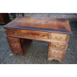 An early 20th century hardwood double pedestal desk, fitted nine drawers, on bracket feet, 48"