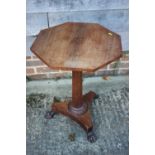 A Regency rosewood octagonal top occasional table, on faceted column and triform base with lion